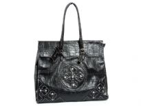 Tote bag with glossy texture and croc pattern has studded accents, a double handle and a top zipper closure. Made of PVC.