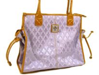 Fleur De Liz Licensed Jacquard Handbag. This spacious bag in jacquard material has leather trim bordering the bag & also hanging tussles on the sides. Top zipper closure.