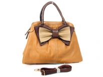 Bow accent dual compartment fashion handbag. Adjustable shoulder strap included. Back zipper pocket.