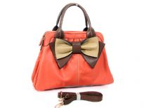 Bow accent dual compartment fashion handbag. Top zipper closing.  Adjustable shoulder strap included. Back zipper pocket.