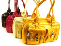 Designer Inspired Handbag has a metallic texture and multiple outside pockets with locks and belts details. Bag has a top zipper closure and a double handle. Made of PU (polyurethane).