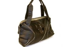 Designer Inspired PU Handbag with broad double shoulder straps & artistic trim design in the front. Top zipper closure.
