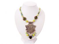 This queenly vintage look necklace has engraved brass tone metal pendant with different shapes of hanging resin beads in shades of lime green & green. Same beads are also on the string which has multiple satin threads in shades of green at the ends. Imported.