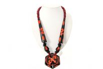 Chunky look black resin necklace with orange carved pattern. Hexagon shape drop pendant gives it a little tribal look. Imported. 
