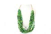 Multiple strings made of small resins in shades of green are attached together with gold tone brass beads chain. 12 strings together gives a chunky & wide look to this statement necklace. 