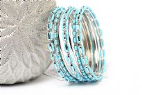 Turquoise Beads Silver Metal Fashion Bangles Set can add zing to any kind of outfit. Set includes 4 thin bangles, 2 petal patterned with beads and 3 bangles having beads in boxy shape. Durable & long lasting quality. 