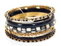 This seven pieces bangles set in silver metal includes different designs of bangles which are painted or studded and in varied widths. Can be matched withe any kind of formal or casual outfit to give that funky look. Made in India.