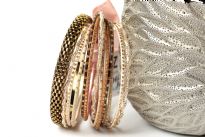 This set of fashionable bangles set includes 14 Pieces in different colors & patterns. Patterned gold colored metal wide bangle with 13 thin bangles which have glitter designs on them. 