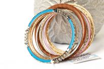 Colorful & Fashionable set of 13 Pieces includes a wooden bangle, a turquoise metal bangle with floral metal design & glittery thin bangles in resin material. Hand crafted & very lightweight.