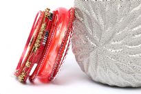 This assorted bangles set in coral color has 12 pieces including 1 resin bangle in bronze colored metal frame, 1 broad resin bangle & 10 thin resin bangles in different patterns. Can be worn all together as a set or individually. Hand crafted. 