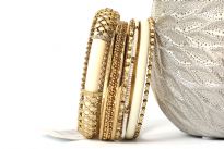 Gold Colored Metal Fashion Bangles Set consists of 8 pieces - one ivory colored wide bangle with metal mesh design, beaded thin bangles & patterned metal bangles also. Can be matched with any kind of outfit for that extra zing. 