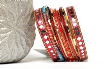 Chic & trendy assorted 11 pieces set of hand crafted fashion bangles consists of 2 wide glittery bangles with mirror pattern, 1 red glittery bangle, 1 colored thread bangle, 4 thin red & 4 thin gold bangles. Can be matched with number of outfits to give that edgy look.