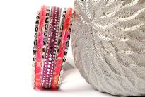 Shiny & Glittery seven piece set of fashion bangles in hot pink hues includes one wide Fuchsia bangle in Aluminium with mirrors design on it, 2 hot pink resin bangles with gold glitter inside them & 4 thin silver bangles. Hand crafted in India.
