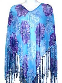 Turquoise colored 100% rayon material poncho top with purple floral print. Long threads like hanging fringes on the edges. Imported.