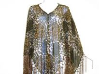 Leopard print v-neck poncho is made of sheer rayon material. Hanging fringes on its border in satin thread material. Imported.