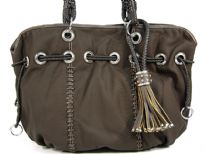 PVC Fashion Handbag which is spacious, has braided double handle, hanging braided accent in the front & drawstring accent at the neck of the bag.
