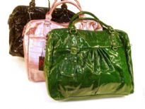 Croco Embossed shining patent leather spacious handbag with double handle, top zipper closure & belt like embellishments also.