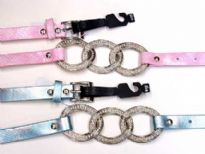 Ladies Belts - Sold Per Dozen. Thin belt with metallic texture has three interlocking rings.